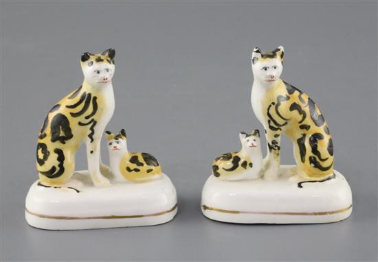 A rare pair of Staffordshire porcelain groups of a cat and a kitten, c.1835-50, H. 7.5 and 7.7cm